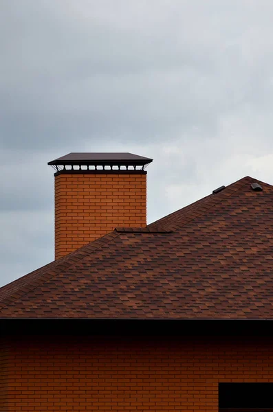 The house is equipped with high-quality roofing of shingles (bitumen tiles). A good example of perfect roofing. The roof is reliably protected from adverse weather conditions
