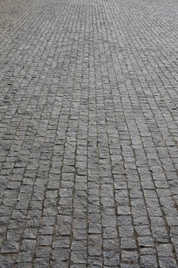 Parlak güneş ışığı altında kare şeklin birçok küçük taşları kaldırım levha (kaldırım taşları) doku