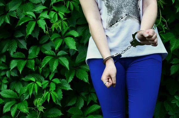 Fragment Young Criminal Girl Body Hands Handcuffs Green Blossoming Ivy — Stock Photo, Image