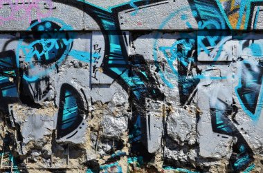Eski bir renkli grafiti duvardaki çizim parçası. Arka plan resmi olarak bir örnek sokak sanatı, vandalizm ve sprey boya ile duvar resmi