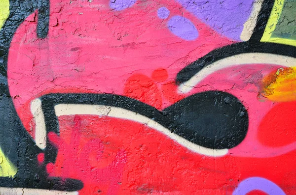 Texture of a fragment of the wall with graffiti painting, which is depicted on it. An image of a piece of graffiti drawing as a photo on street art and graffiti culture topics