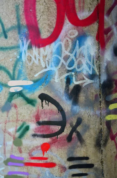 Texture of a fragment of the wall with graffiti painting, which is depicted on it. An image of a piece of graffiti drawing as a photo on street art and graffiti culture topics