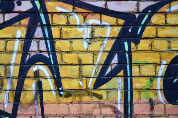 Texture of a fragment of the wall with graffiti painting, which is depicted on it. An image of a piece of graffiti drawing as a photo on street art and graffiti culture topics