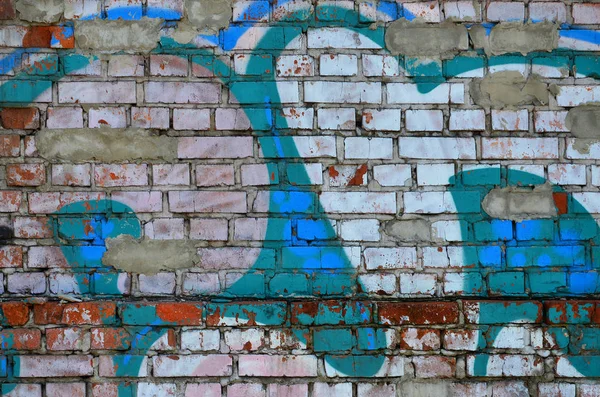 Texture of a fragment of the wall with graffiti painting, which is depicted on it. An image of a piece of graffiti drawing as a photo on street art and graffiti culture topics