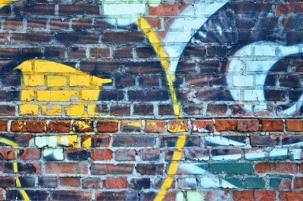 Texture of a fragment of the wall with graffiti painting, which is depicted on it. An image of a piece of graffiti drawing as a photo on street art and graffiti culture topics