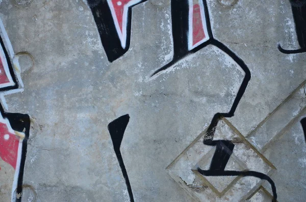 Texture of a fragment of the wall with graffiti painting, which is depicted on it. An image of a piece of graffiti drawing as a photo on street art and graffiti culture topics