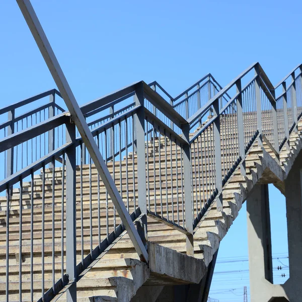 A fragment of a stepped ascent to the pedestrian bridge between the platforms of the railway station