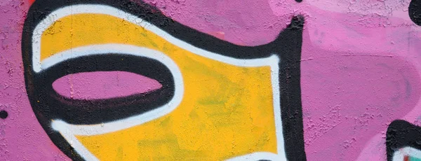 Fragment of a beautiful graffiti pattern in pink and green with a black outline. Street art background image