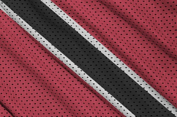 Trinidad and Tobago flag printed on a polyester nylon sportswear mesh fabric with some folds — Stock Image Trinidad Tobago Flag Printed Polyester Nylon Sportswear Mesh Fabric Some Stock Photo