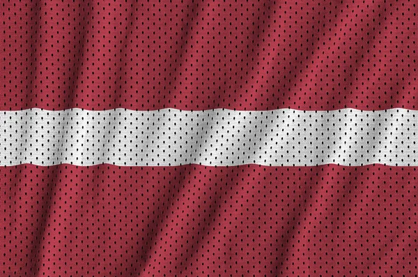Latvia flag printed on a polyester nylon sportswear mesh fabric — Stock Photo, Image