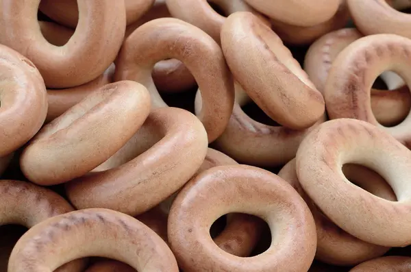 Close-up photo of fresh yellow bagels. A popular kind of flour p — Stock Photo, Image