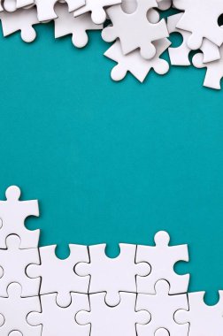 Katlanmış bir beyaz jigsaw puzzle ve bir yığın uncombed bulmaca öğeleri arka planı mavi bir yüzey parçası. Metin için yer ile doku fotoğraf