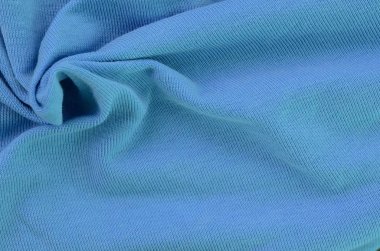 The texture of the fabric in blue color. Material for making shirts and blouses clipart
