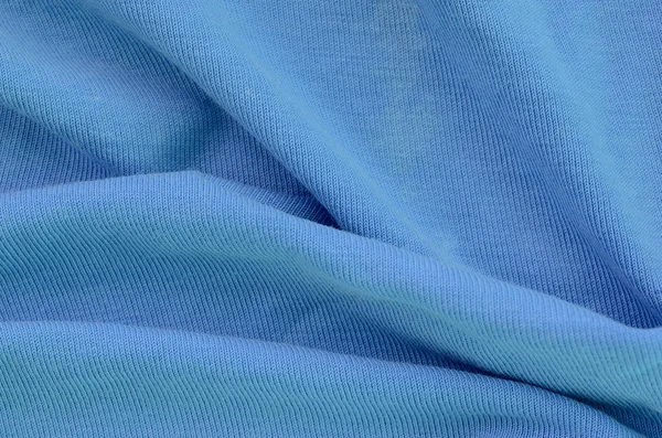 A textura do tecido na cor azul. Material para fazer camisas e blusas — Fotografia de Stock