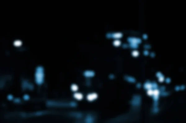 Blurred night scene of traffic on the roadway. Defocused image of cars traveling with luminous headlights. Bokeh Art — Stock Photo, Image