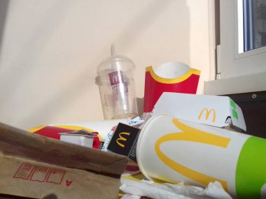 Kullanılmış kağıt ambalajlar ve üzerinde McDonalds 'ın tasarımı ve logosu olan tek kullanımlık paketler. Mcdonalds kullanımdan sonra çöpü geri dönüştürür