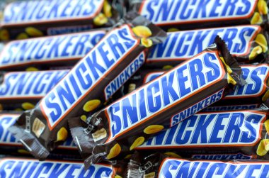 Bir sürü Snickers çikolatası üst üste yığılmış. Snickers çikolataları Mars Anonim Şirketi tarafından üretilir. Snickers 1930 yılında Franklin Clarence Mars tarafından yaratıldı.