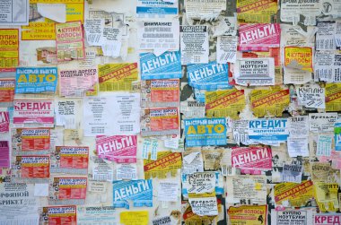 Kharkov, Ukrayna - 2 Ekim 2019: Grunge Mesaj Kurulu birçok reklamla birlikte. İnsanlar beyaz kağıda reklam ve bilgi yayıyorlar, metal çitlere asmaktansa.