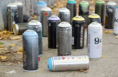 Kharkov, Ukrayna - 19 Ekim 2019: Montana mtn 94 siyah sert uyuşturucu ve kobra sonbahar yapraklarında grafiti yapmak için sprey kutu kullandılar