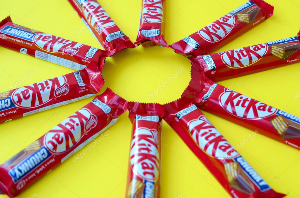 Kit Kat barras de chocolate en rojo envoltura se encuentra en el fondo amarillo. Kit kat creado