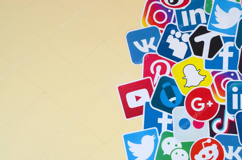 KHARKOV, UKRAINE - OCTOBER 17, 2019: Many paper icons with logo of most popular social networks and smartphone apps for chat and conversations online