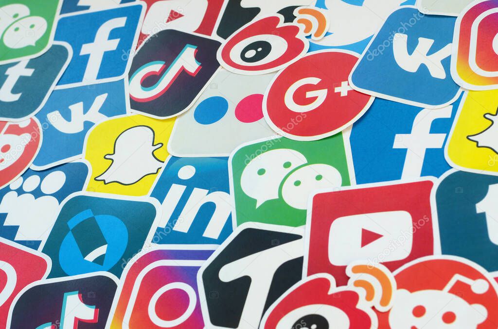 KHARKOV, UKRAINE - OCTOBER 17, 2019: Many paper icons with logo of most popular social networks and smartphone apps for chat and conversations online