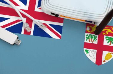 Masada internet rj45 kablo, kablosuz usb wi-fi adaptör ve yönlendirici ile Fiji bayrağı tasvir edilmiştir. İnternet bağlantısı kavramı