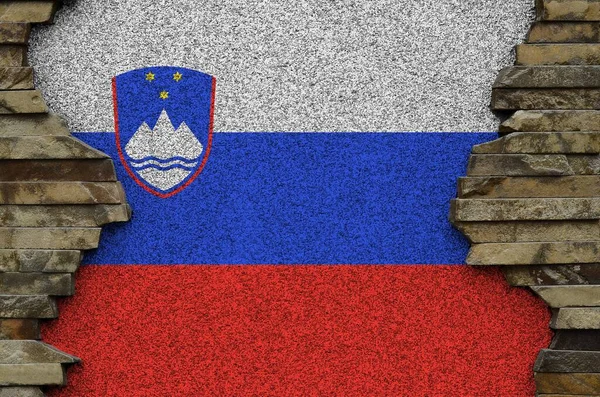 Slovenia flag depicted in paint colors on old stone wall close up. Textured banner on rock wall background