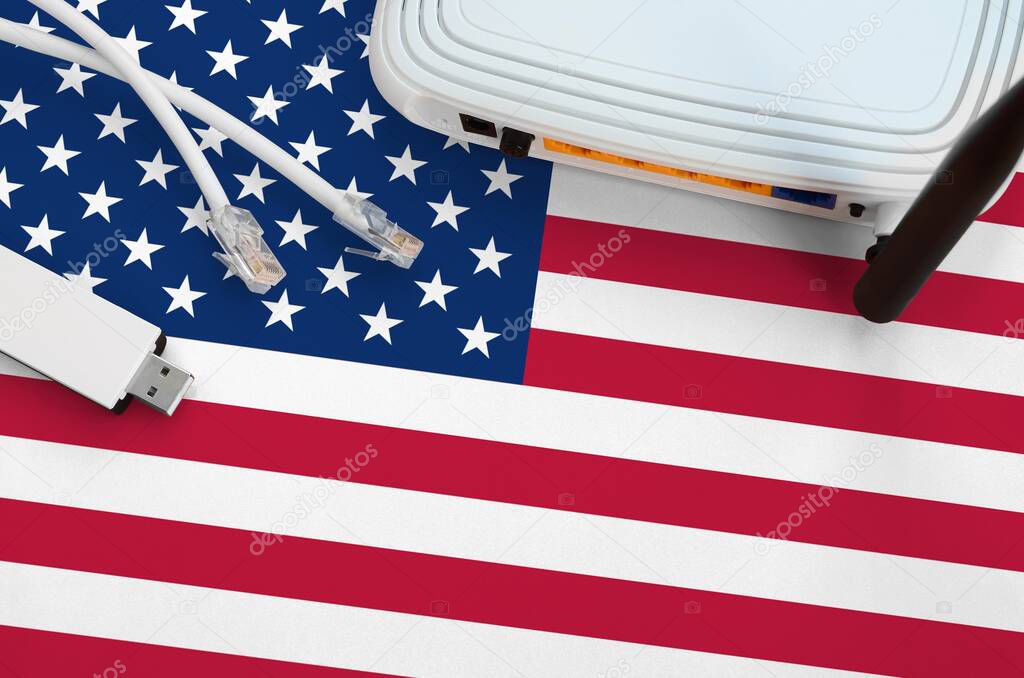 United States of America flag depicted on table with internet rj45 cable, wireless usb wi-fi adapter and router. Internet connection concept