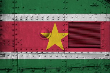 Suriname flag depicted on side part of military armored tank close up. Army forces conceptual background clipart