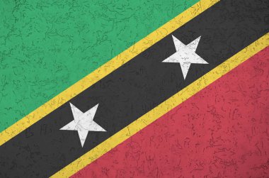 Saint Kitts ve Nevis bayrağı eski duvarlara parlak boya renkleri çizilmişti. Kabataslak arkaplanda desenli pankart