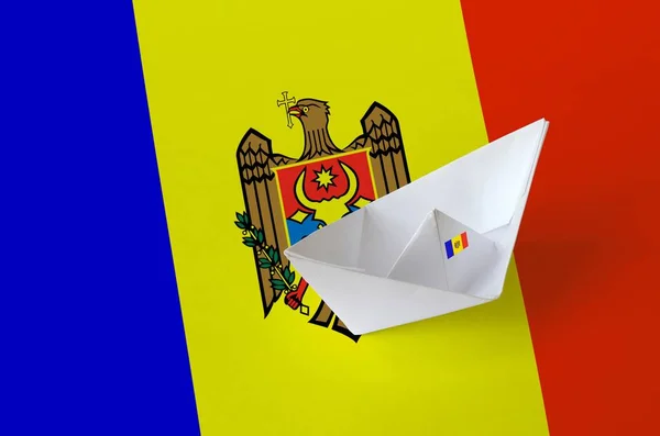 Moldova flag depicted on paper origami ship closeup. Oriental handmade arts concept