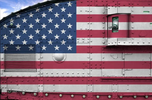 United States of America flag depicted on side part of military armored tank close up. Army forces conceptual background