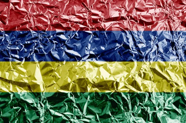 Mauritius flag depicted in paint colors on shiny crumpled aluminium foil close up. Textured banner on rough background