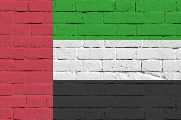 United Arab Emirates flag depicted in paint colors on old brick wall close up. Textured banner on big brick wall masonry background