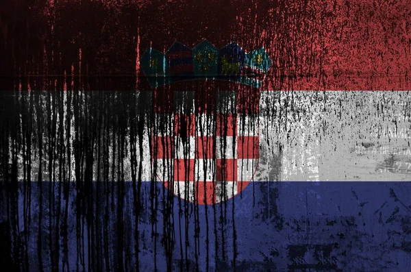 Croatia flag depicted in paint colors on old and dirty oil barrel wall close up. Textured banner on rough background