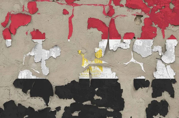 Egypt flag depicted in paint colors on old obsolete messy concrete wall close up. Textured banner on rough background