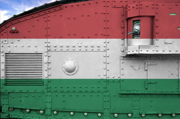Hungary flag depicted on side part of military armored tank close up. Army forces conceptual background