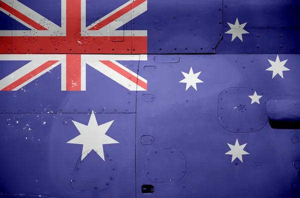 Australia flag depicted on side part of military armored helicopter close up. Army forces aircraft conceptual background