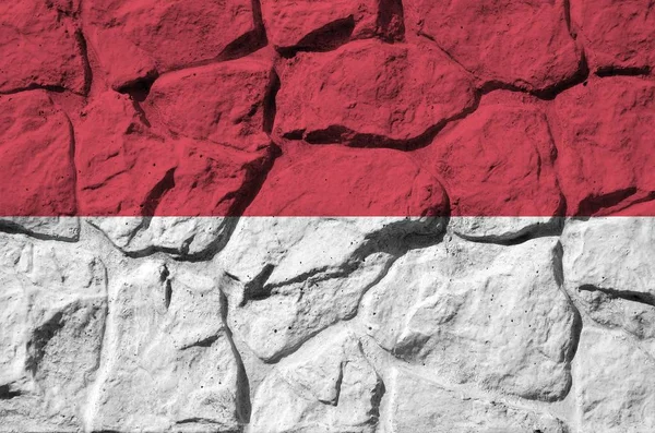 古い石の壁にペイント色で描かれたモナコの旗が閉じます 岩壁の背景にテクスチャバナー — ストック写真