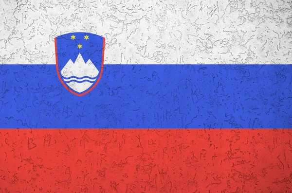 Slovenia flag depicted in bright paint colors on old relief plastering wall close up. Textured banner on rough background