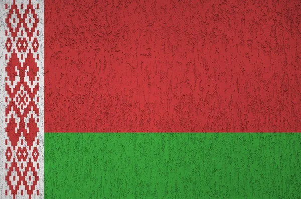 Belarus flag depicted in bright paint colors on old relief plastering wall close up. Textured banner on rough background