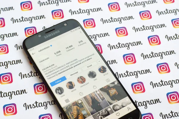 Calvin Klein official instagram account on smartphone screen on paper instagram banner. — Stock Photo, Image