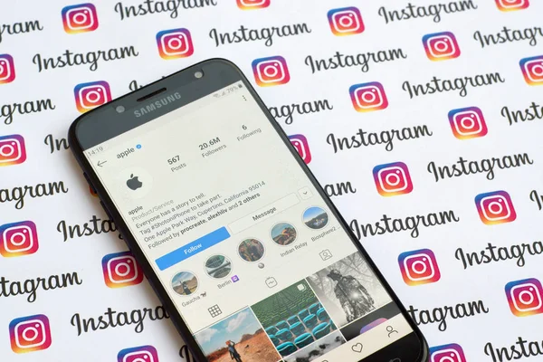 Apple official instagram account on smartphone screen on paper instagram banner. — Stock Photo, Image