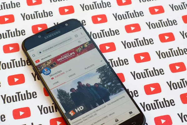 Movieclips official youtube channel on smartphone screen on paper youtube background. — Stock Photo, Image