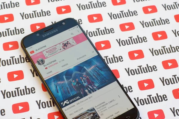 Blackpink official youtube channel on smartphone screen on paper youtube background. — Stock Photo, Image
