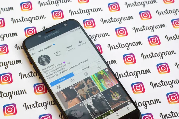 Selena Gomez official instagram account on smartphone screen on paper instagram banner. — Stock Photo, Image