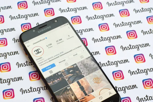 Chanel official instagram account on smartphone screen on paper instagram banner. — Stock Photo, Image