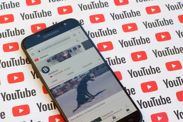 Badabun official youtube channel on smartphone screen on paper youtube background. — Stock Photo, Image