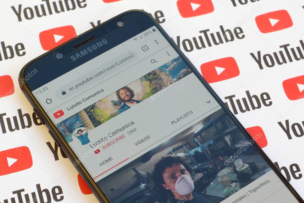 NY, USA - DECEMBER 4, 2019: Luisito Comunica official youtube channel on smartphone screen on paper youtube background.